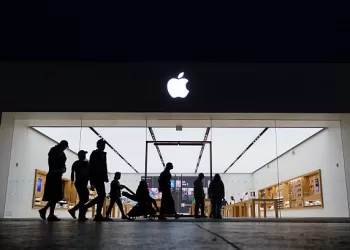 SAN DIEGO, CALIFORNIA - MAY 1: People walk by an Apple store at the Westfield UTC shopping center on May 1, 2025 in San Diego, California. (Photo by Kevin Carter/Getty Images)