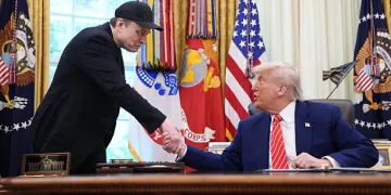EO Elon Musk shakes hands with U.S. President Donald Trump