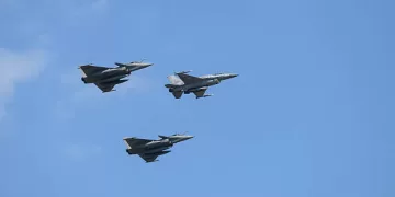 A Polish air force F-16 is flanked on either side by Dassault Rafale fighter jets as they perform a flyover during the National Army Day military parade in Warsaw, Poland, on August 15, 2025. Thousands of members of the Polish armed forces take part in the Armed Forces Day military parade that takes place annually on August 15 to commemorate Poland's victory over the Soviet Union's army in 1920. (Photo by Aleksander Kalka/NurPhoto via Getty Images)